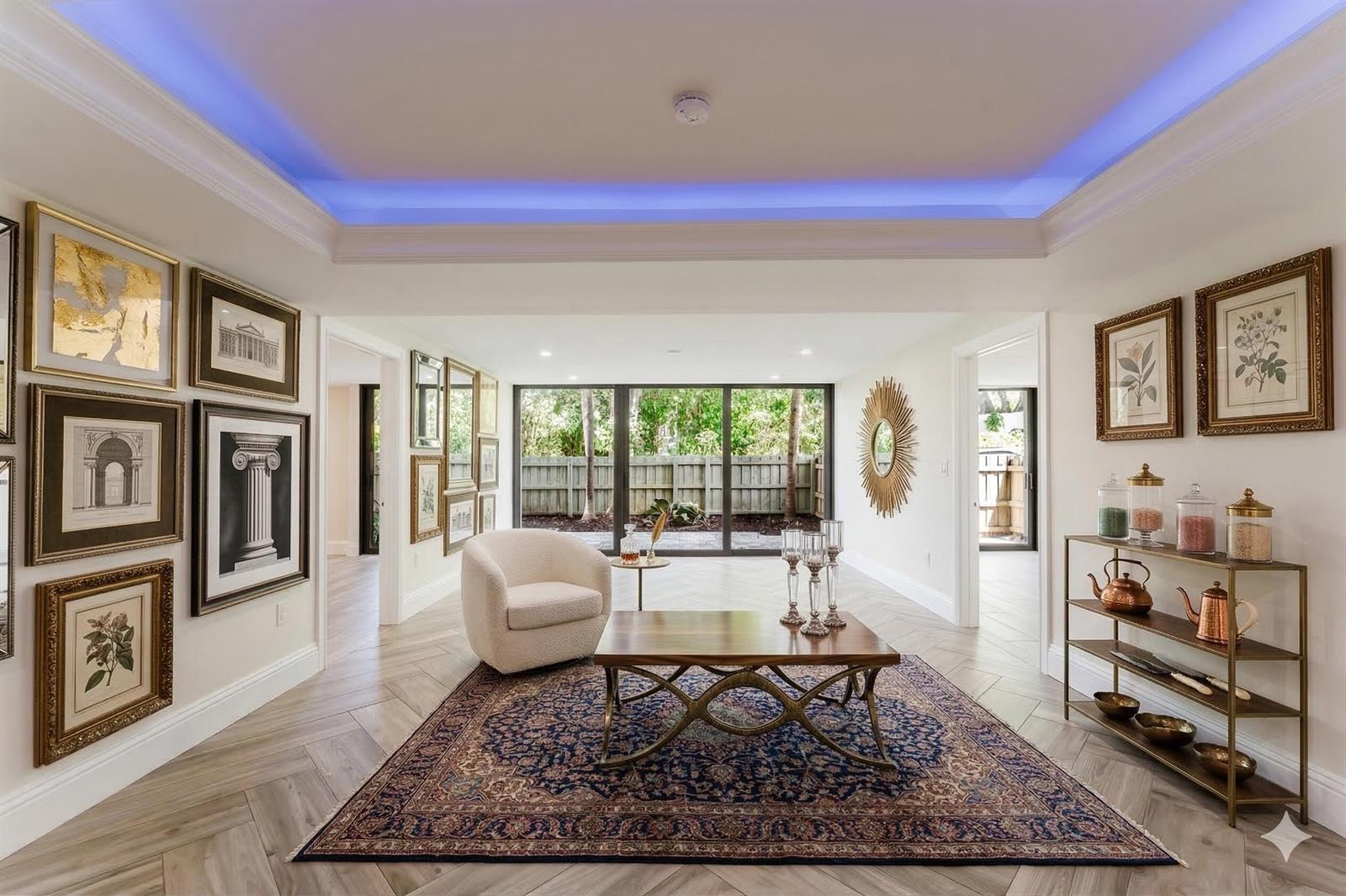 A living room features a tray ceiling with blue lighting, herringbone floors, and a rug — 501 SW 11th Place # 114, Boca Raton FL 33432, BOCA RATON, FL