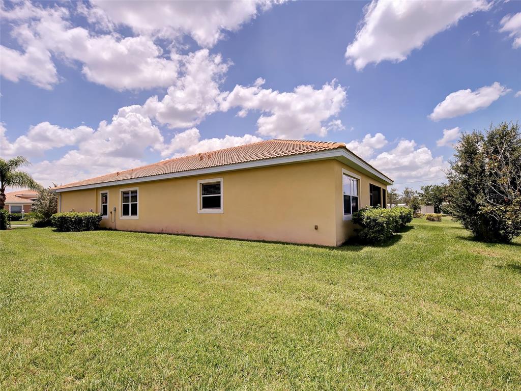 An entryway features a white front door, tiled floors, a wooden cabinet, and a mirror — 8938 PEREGRINE WAY, NORTH PORT, FL