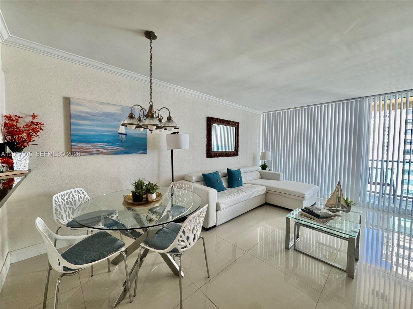 A bright living and dining area features white tile floors, a glass table, and sectional — 2501 S Ocean Dr, Hollywood FL 33019, HOLLYWOOD, FL
