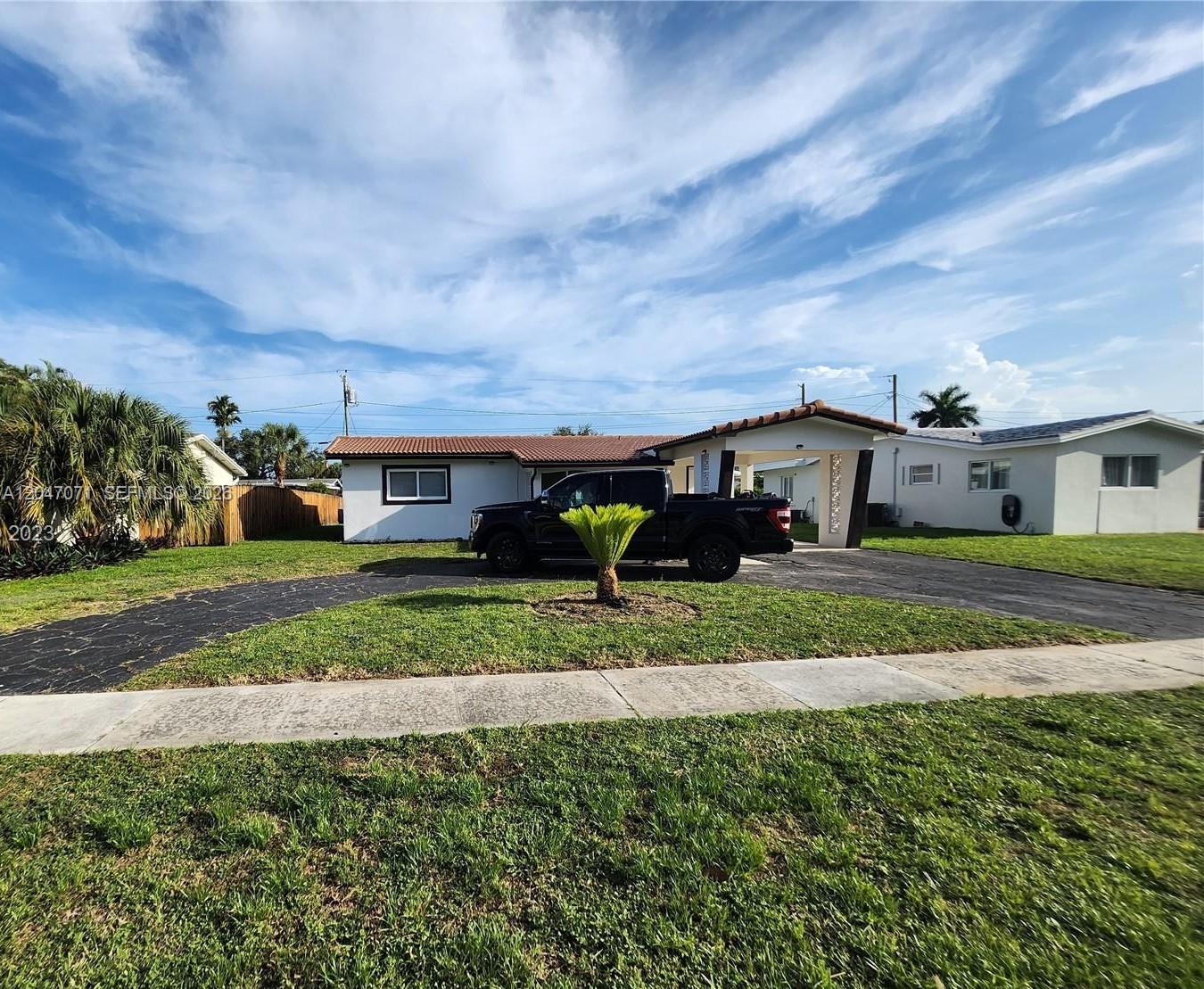 A single-story house with a carport and a black pickup truck in the driveway — 3346 Coolidge St, Hollywood FL 33021, HOLLYWOOD, FL