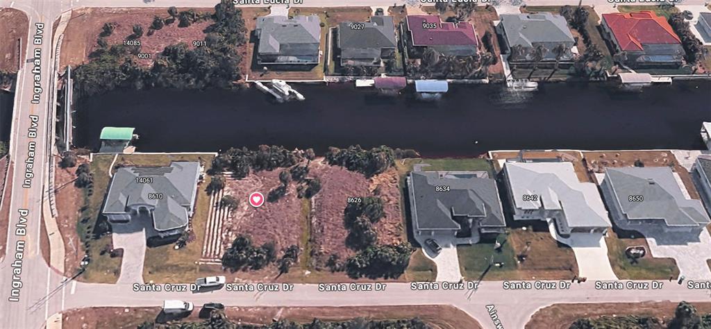 This aerial map view shows a vacant waterfront lot situated between two residential homes — 8618 SANTA CRUZ DRIVE, PORT CHARLOTTE, FL