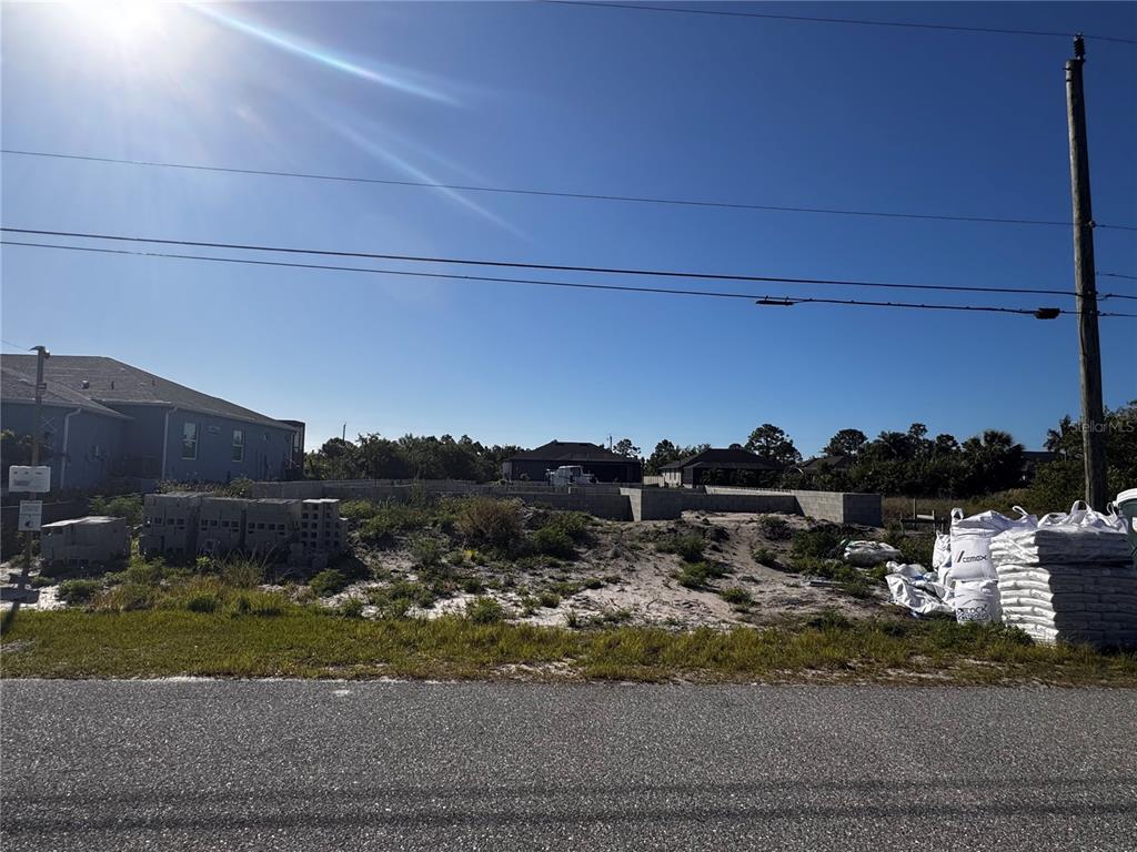A vacant residential lot features a concrete block foundation under construction — 8618 SANTA CRUZ DRIVE, PORT CHARLOTTE, FL