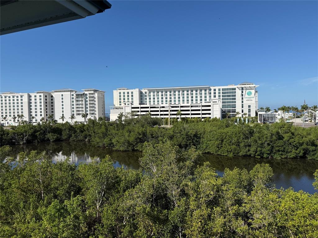 A view of the Sunseeker Resort across a body of water and mangrove trees — 5119 MELBOURNE STREET UNIT C304, PUNTA GORDA, FL