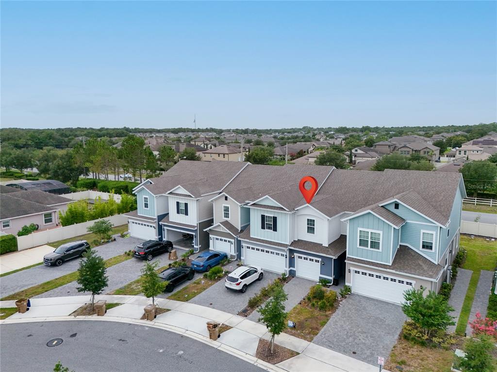 An aerial view shows a row of attached townhomes with a red location pin — 1220 WYCLIFFE WAY, ST CLOUD, FL