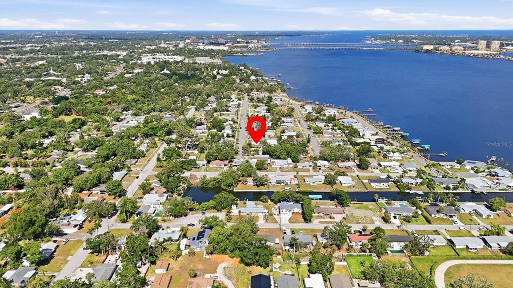 This aerial view shows a residential neighborhood near a large body of water — 101 20TH STREET NE, BRADENTON, FL