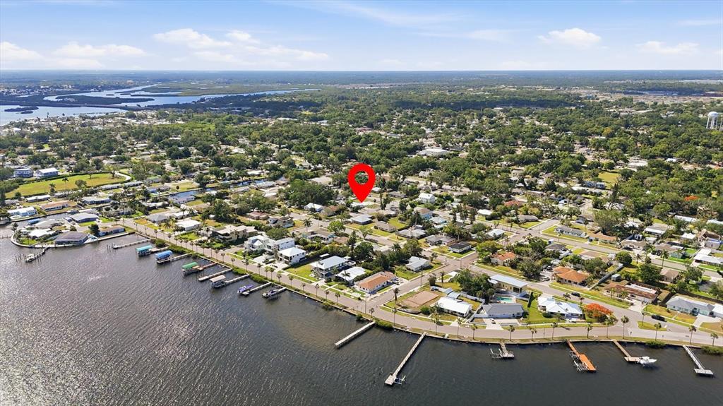 An aerial view shows a residential neighborhood along a waterfront with a red location pin — 101 20TH STREET NE, BRADENTON, FL