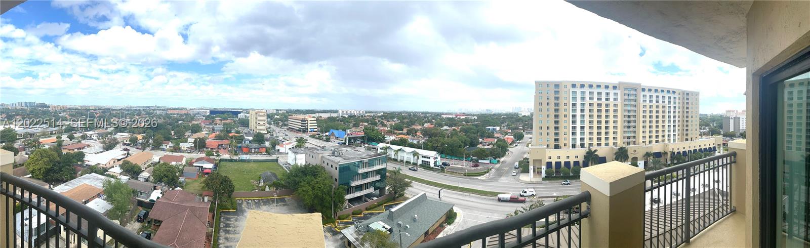 A panoramic view from a balcony overlooking a suburban landscape with buildings and roads — 4242 NW 2nd St # 1002, Miami FL 33126, MIAMI, FL