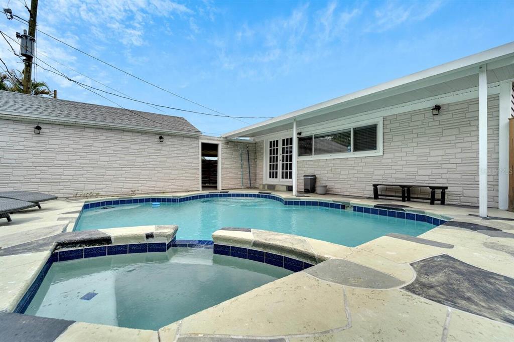 A single-story house with brown siding, a front porch, and a concrete walkway — 2219 16TH STREET N, ST PETERSBURG, FL