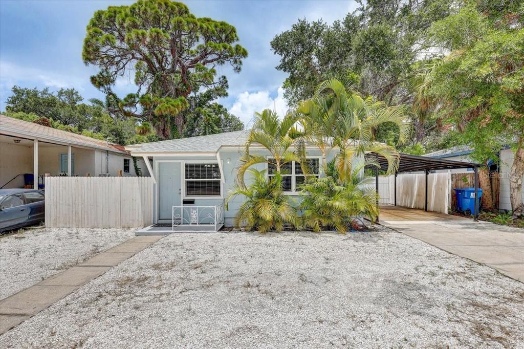 A light blue single-story house features a gravel front yard, palm trees, and a carport — 2901 DR MARTIN LUTHER KING JR STREET S, ST PETERSBURG, FL