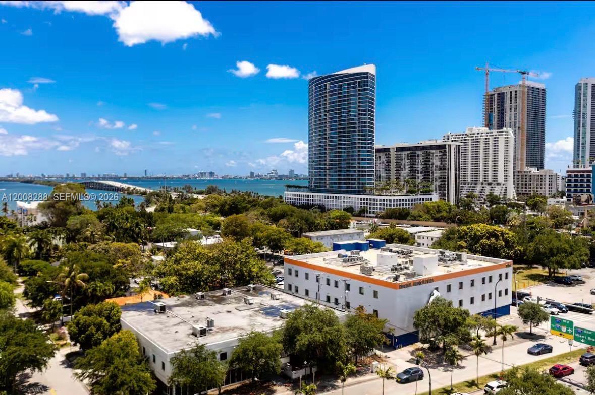 An aerial view shows a low-rise building in the foreground with high-rise towers behind it — 3900 Biscayne Blvd # 906, Miami FL 33137, MIAMI, FL