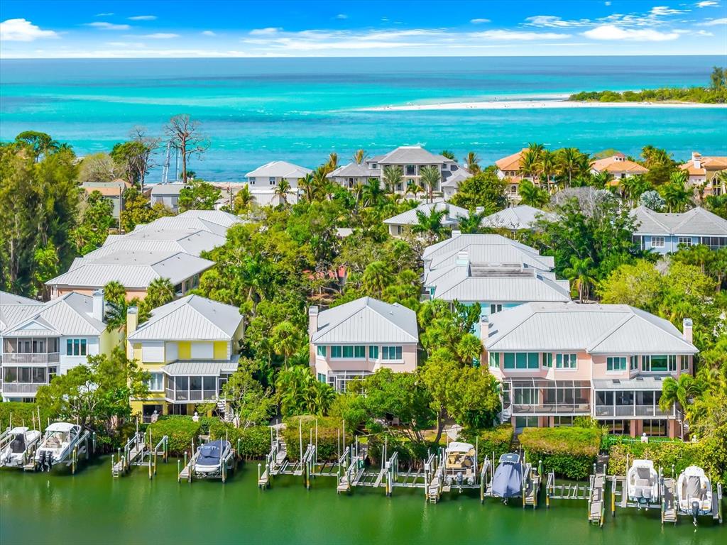 An aerial view of waterfront houses with private boat docks along a canal — 3941 HAMILTON CLUB CIRCLE UNIT 9, SARASOTA, FL