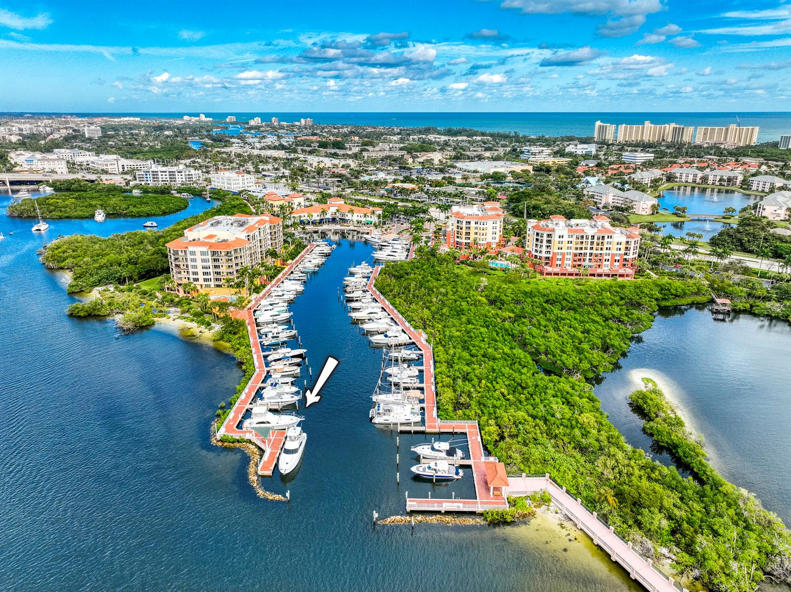 An aerial view shows a marina with numerous boats docked along piers near residential buildings — 348 S Us Highway 1, Jupiter FL 33477, JUPITER, FL