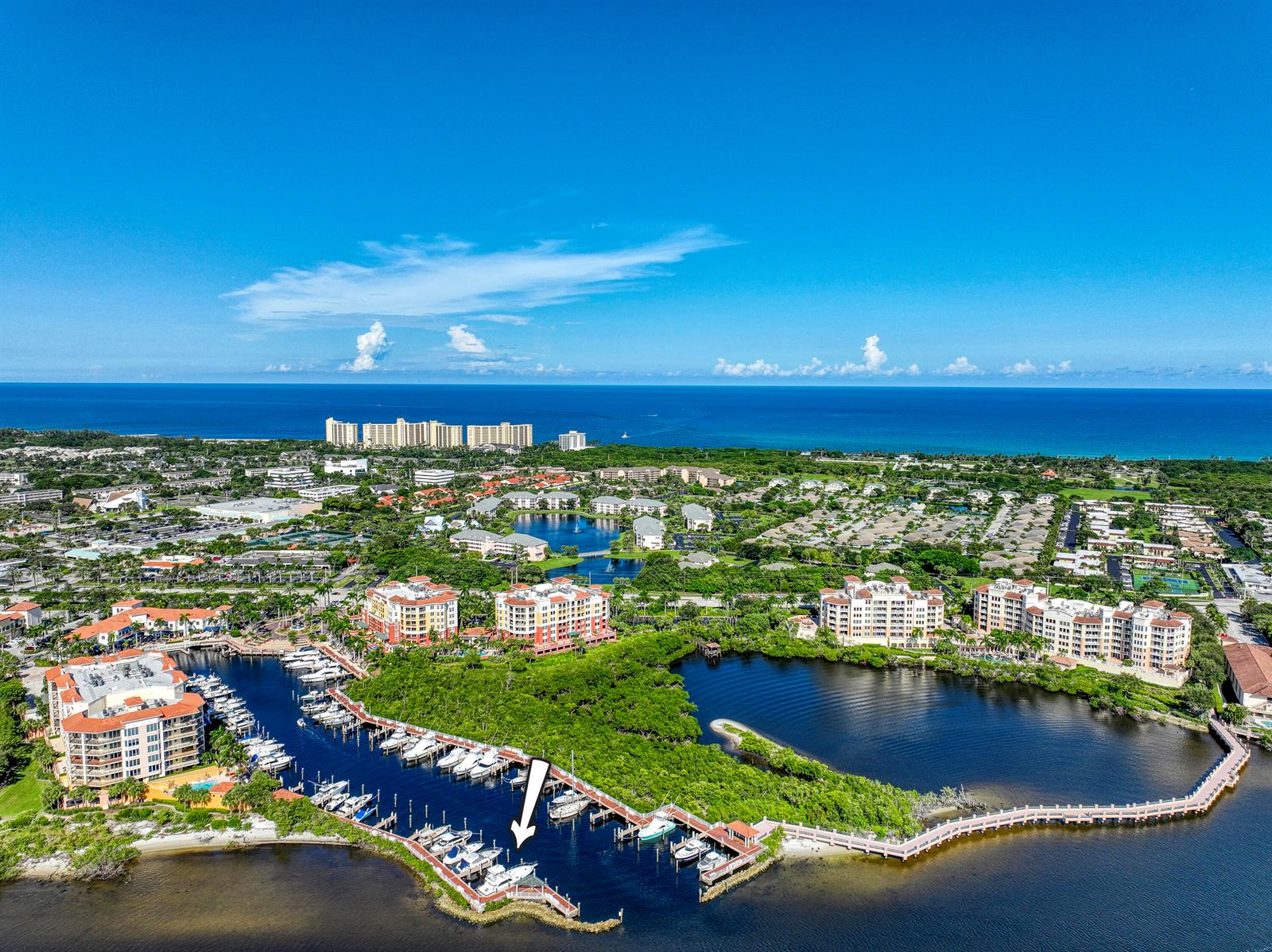 An aerial view shows a marina with docked boats and surrounding residential buildings near water — 348 S Us Highway 1, Jupiter FL 33477, JUPITER, FL