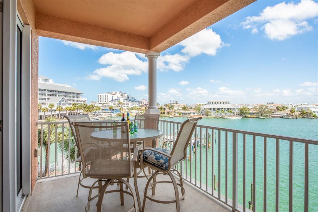 An aerial view of a coastal resort area with a red arrow pointing to a building — 530 S GULFVIEW BOULEVARD UNIT 303, CLEARWATER, FL