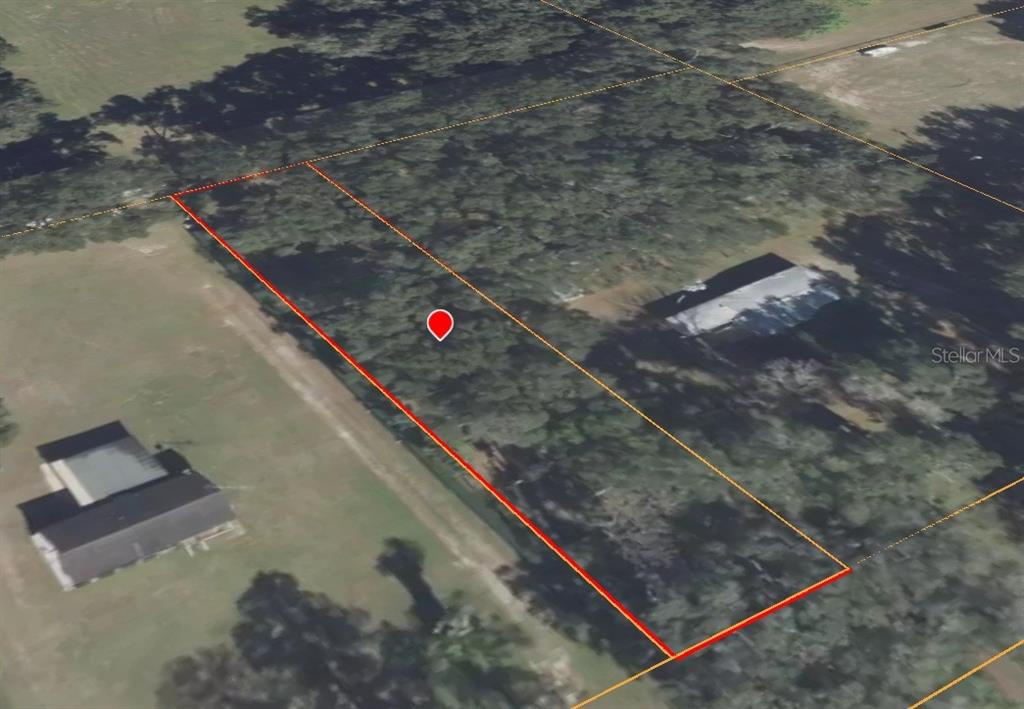 This aerial view shows a rectangular, tree-covered vacant lot outlined in red — 0 SE 39TH AVENUE, OCALA, FL