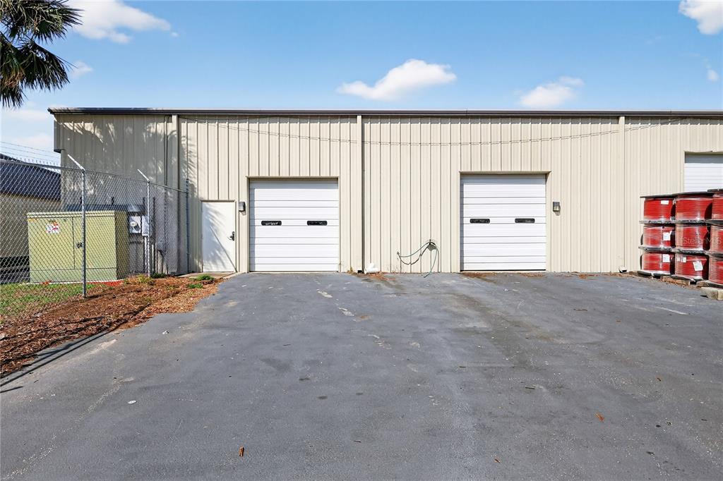 An exterior view of a metal warehouse building with two roll-up doors and a side entrance — 300 RICHEY ROAD UNIT 3 & 4, LEESBURG, FL