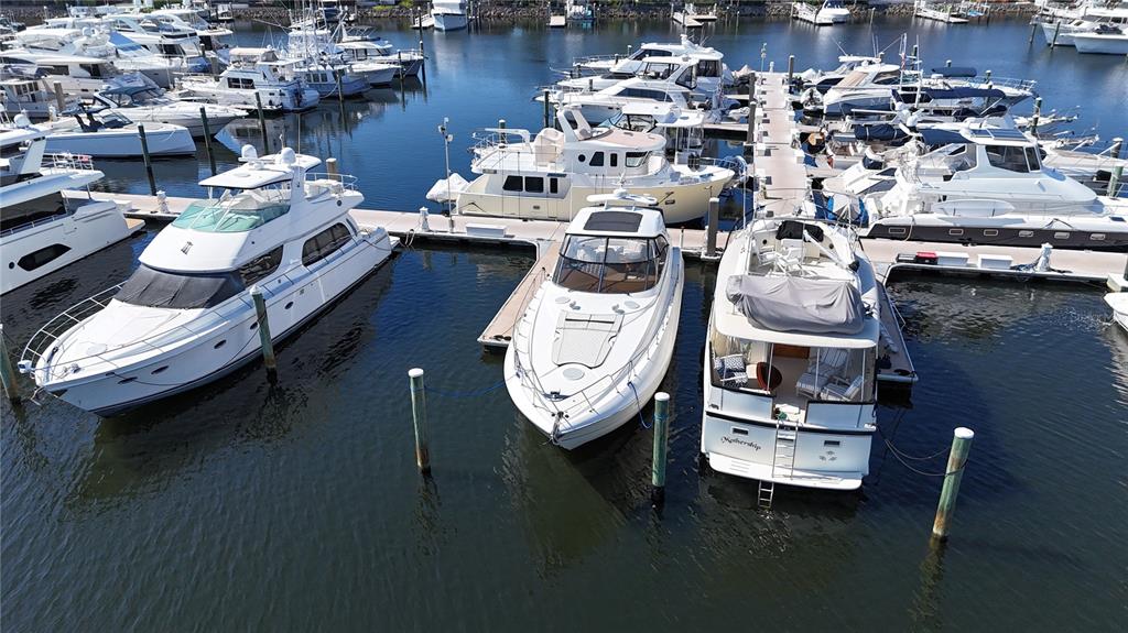 An aerial view shows several white yachts docked at a marina on a sunny day — 102 RIVIERA DUNES WAY UNIT S-21, PALMETTO, FL