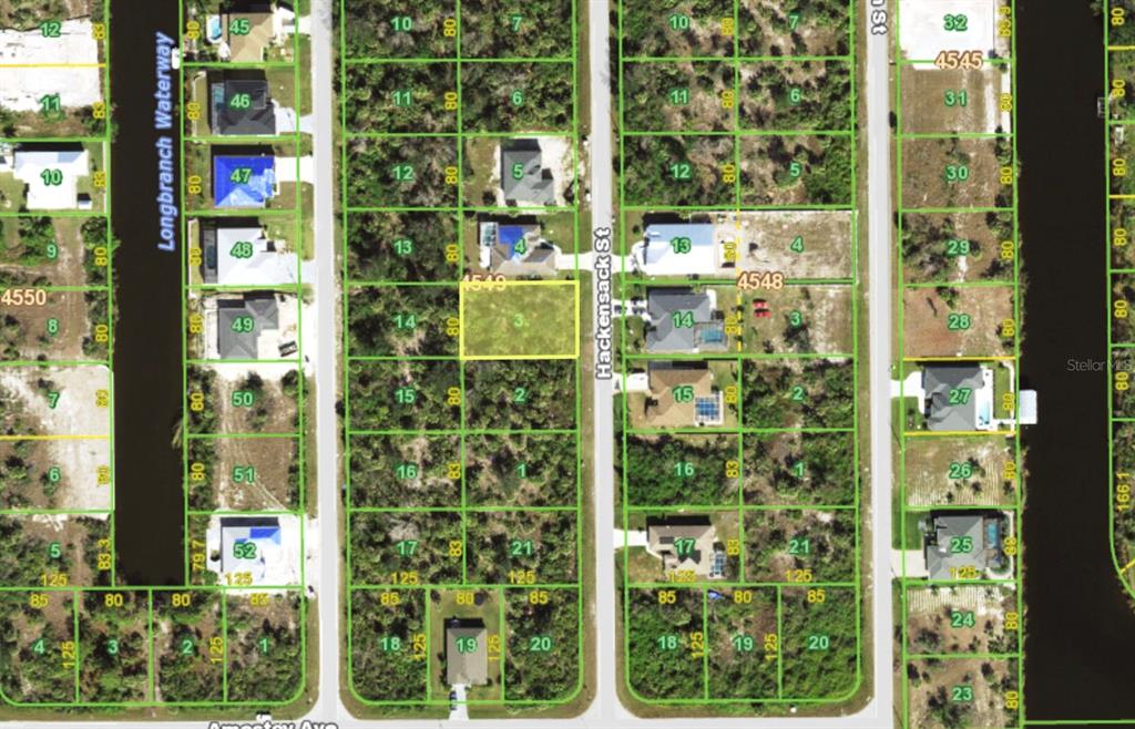 This is an aerial map showing residential lots and houses along a street and waterway — 10051 HACKENSACK STREET, PORT CHARLOTTE, FL