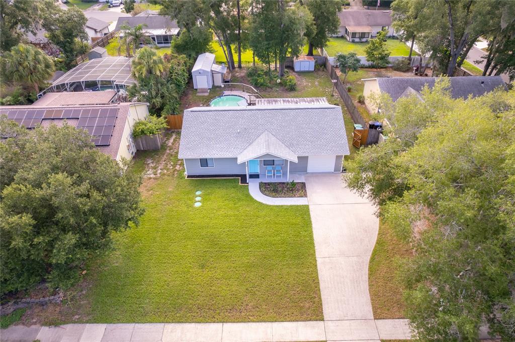 An aerial view shows a single-story house with a gray roof, pool, and front lawn — 15 N BULOVA DRIVE, APOPKA, FL