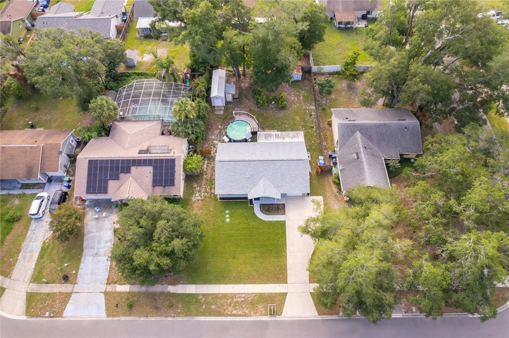 An aerial view shows two suburban houses with driveways, lawns, and backyard swimming pools — 15 N BULOVA DRIVE, APOPKA, FL