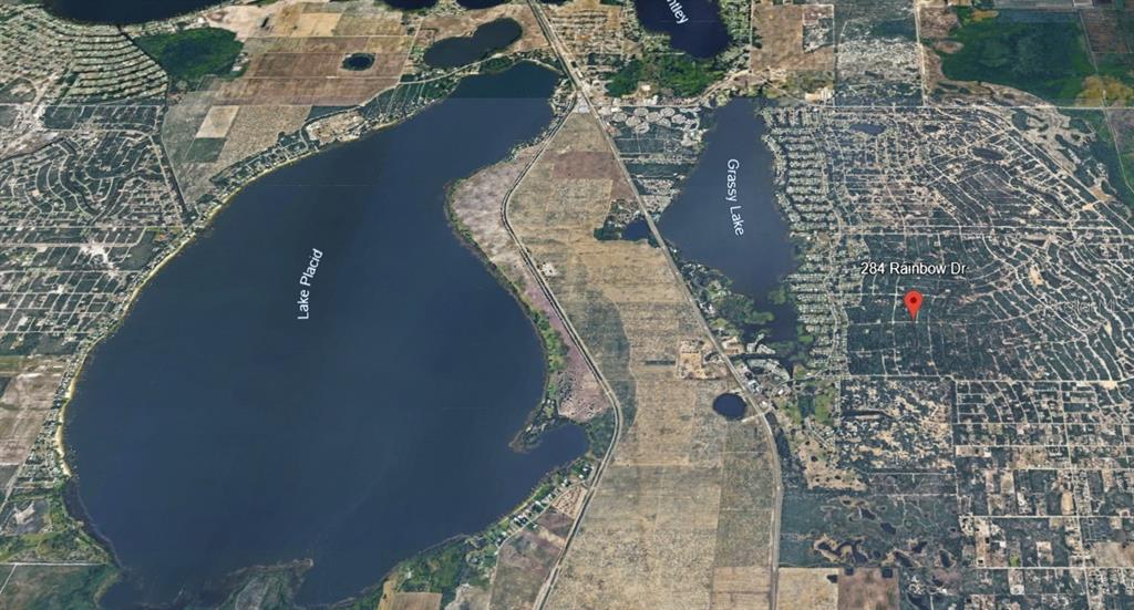 This aerial map shows Lake Placid and Grassy Lake with a red pin marking property — 284 RAINBOW DRIVE, LAKE PLACID, FL