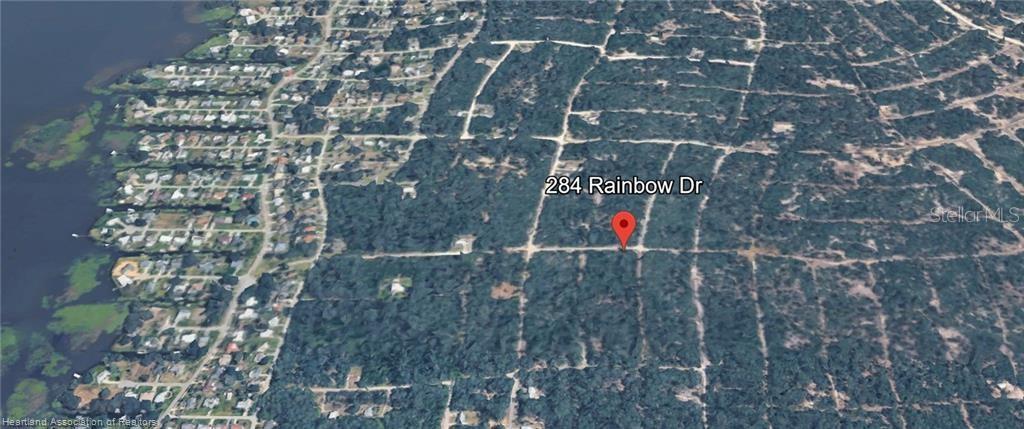 This is an aerial map view showing a wooded residential lot with a location pin — 284 RAINBOW DRIVE, LAKE PLACID, FL