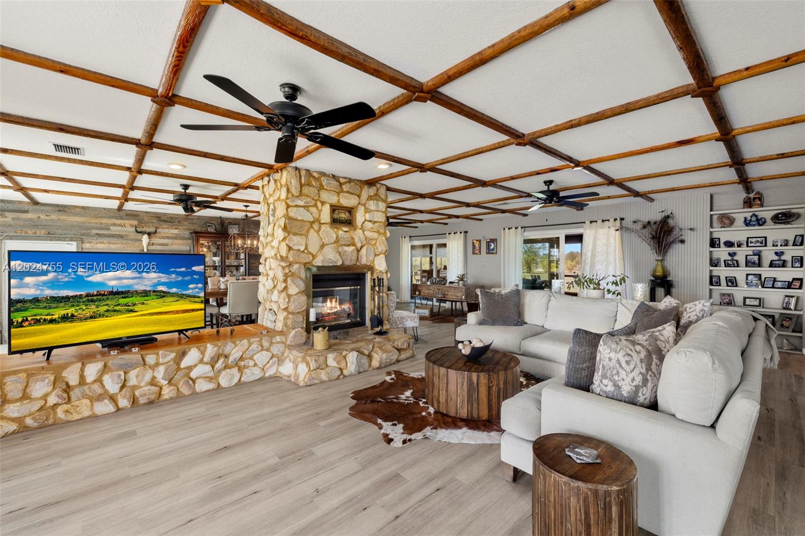 A living room features a stone fireplace, wood-beamed ceiling, and a light-colored sectional sofa — OTHER CITY - IN THE STATE OF FLORIDA, FL