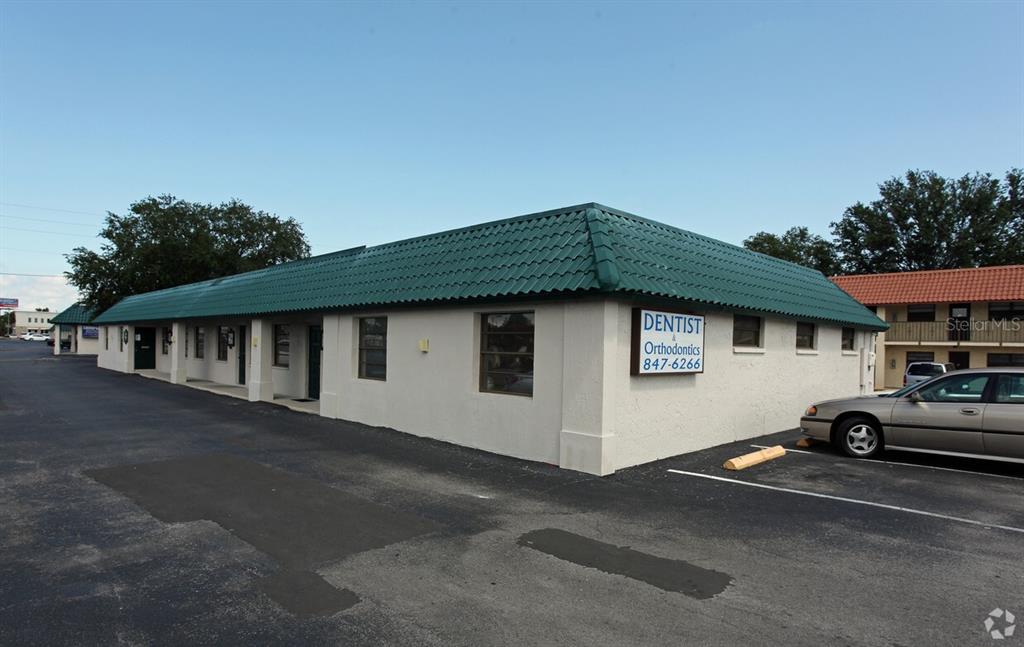 A single-story commercial building with a green metal roof and a dentist office sign — 6609 RIDGE ROAD UNIT 2&4, PORT RICHEY, FL