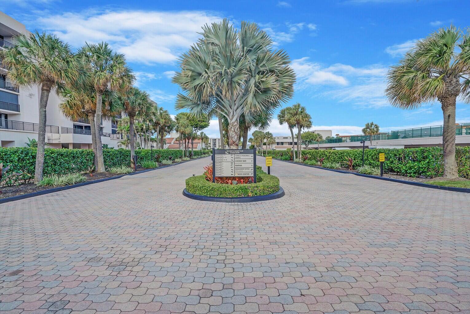 A paved driveway leads to a central directory sign surrounded by palm trees and landscaping — 2687 N Ocean Boulevard # 305, Boca Raton FL 33431, BOCA RATON, FL