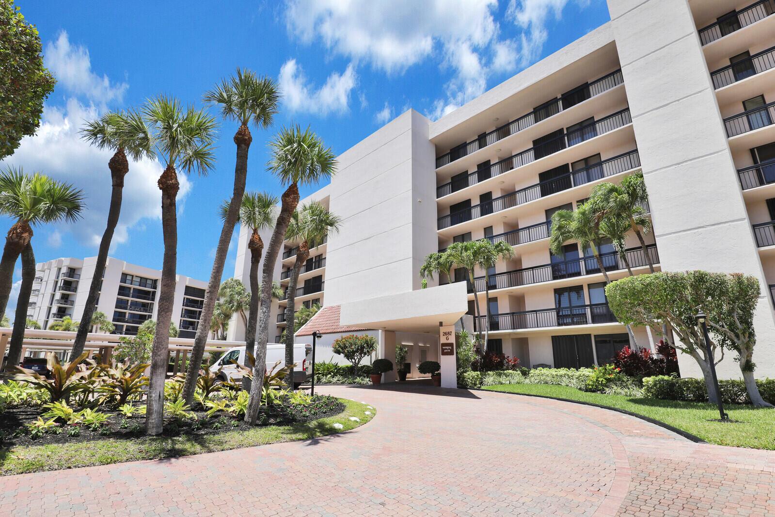 A multi-story residential building with a paved driveway, palm trees, and a covered entrance — 2687 N Ocean Boulevard # 305, Boca Raton FL 33431, BOCA RATON, FL