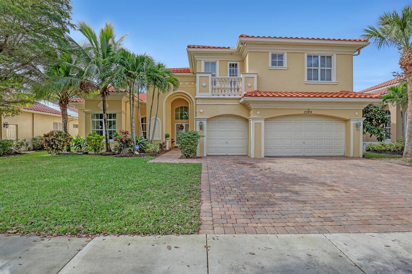 A two-story yellow stucco house with a red tile roof and a brick paver driveway — 3389 Lago De Talavera, Lake Worth FL 33467, LAKE WORTH, FL