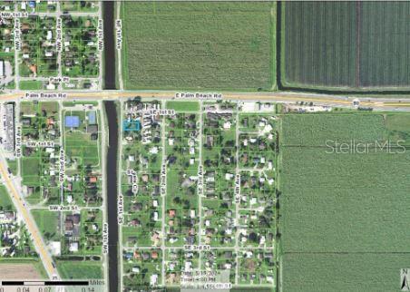 This is an aerial map showing a residential neighborhood with a highlighted property lot — 205 SE 1ST AVENUE, SOUTH BAY, FL