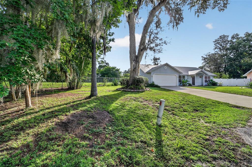 A single-story house with a garage and a large tree in the front yard — 4861 SE 31ST TERRACE, OCALA, FL