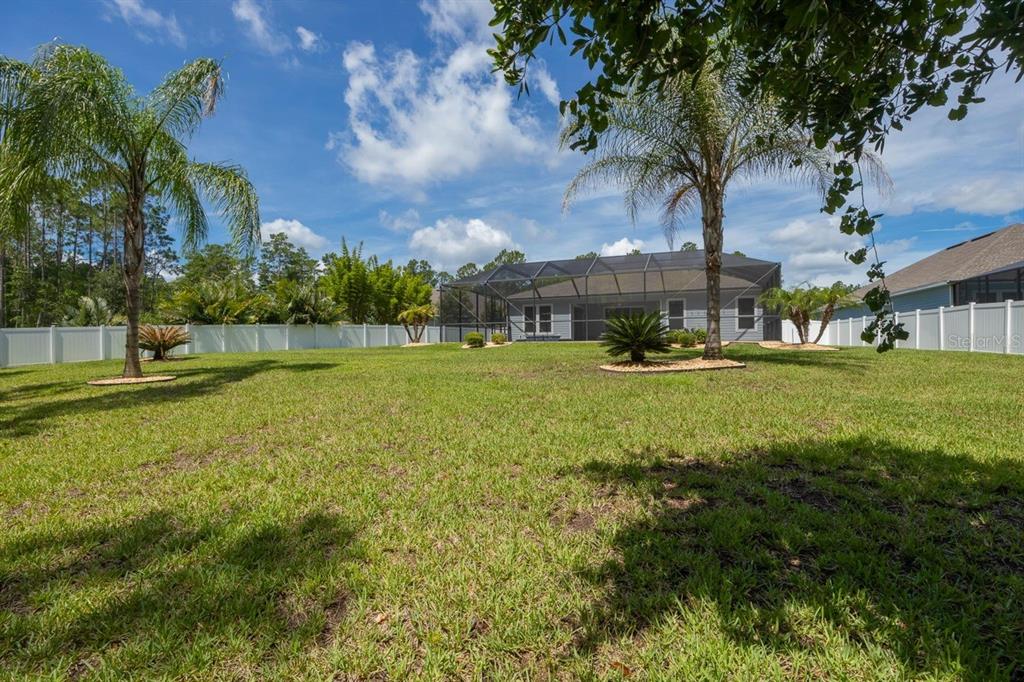 A kitchen features gray cabinets, a double wall oven, and a white pantry door — 213 OLETA WAY, ST AUGUSTINE, FL