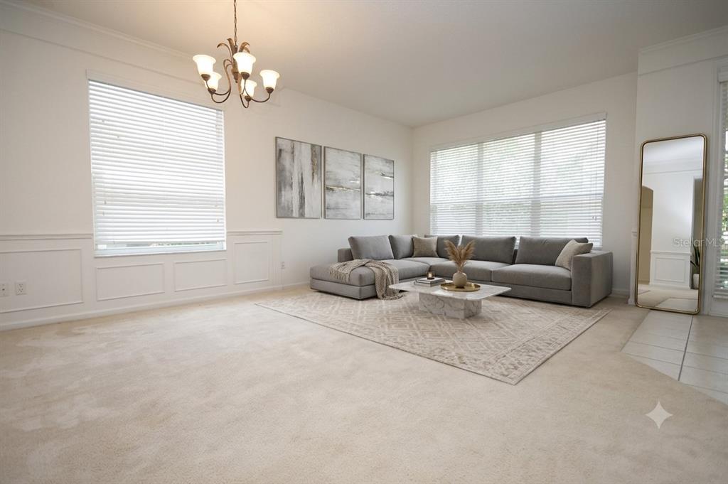 A living room features a gray sectional sofa, a marble coffee table, and wall molding — 13424 HOPKINTON CT, WINDERMERE, FL