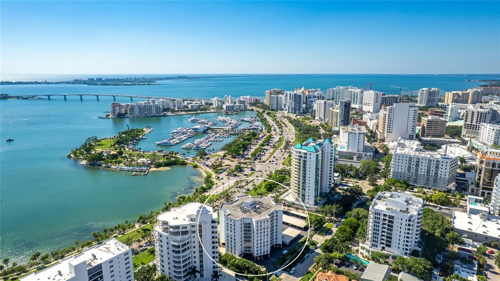 An elevated view of a coastal park, marina, and city skyline under a clear sky — 435 S GULFSTREAM AVENUE UNIT 1004, SARASOTA, FL