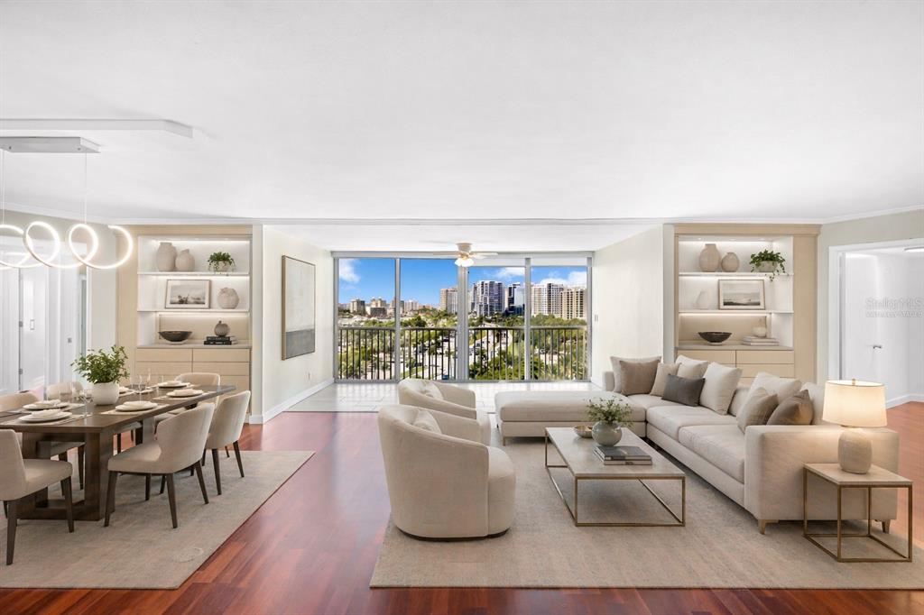 An aerial view shows a white multi-story residential building circled in a coastal city — 435 S GULFSTREAM AVENUE UNIT 1004, SARASOTA, FL