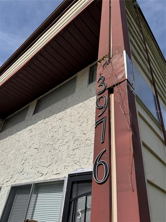 The exterior of a building features a vertical column displaying the house number 3976 — 3976 CRAYRICH CIRCLE UNIT C1, ORLANDO, FL