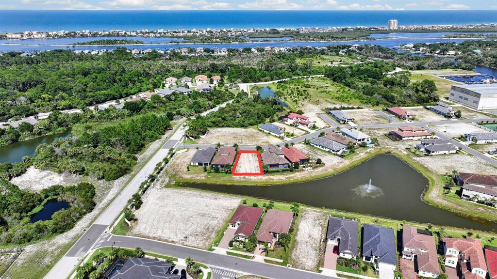 An aerial view shows a vacant residential lot outlined in red within a coastal neighborhood — 7 RIO VISTA DRIVE, PALM COAST, FL