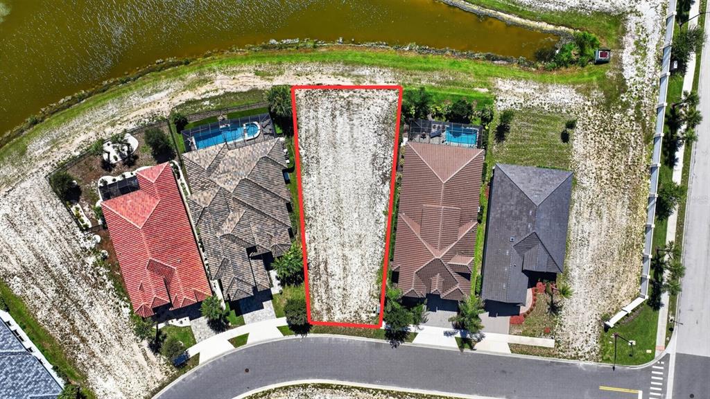 An aerial view shows a vacant residential lot outlined in red between two existing houses — 7 RIO VISTA DRIVE, PALM COAST, FL