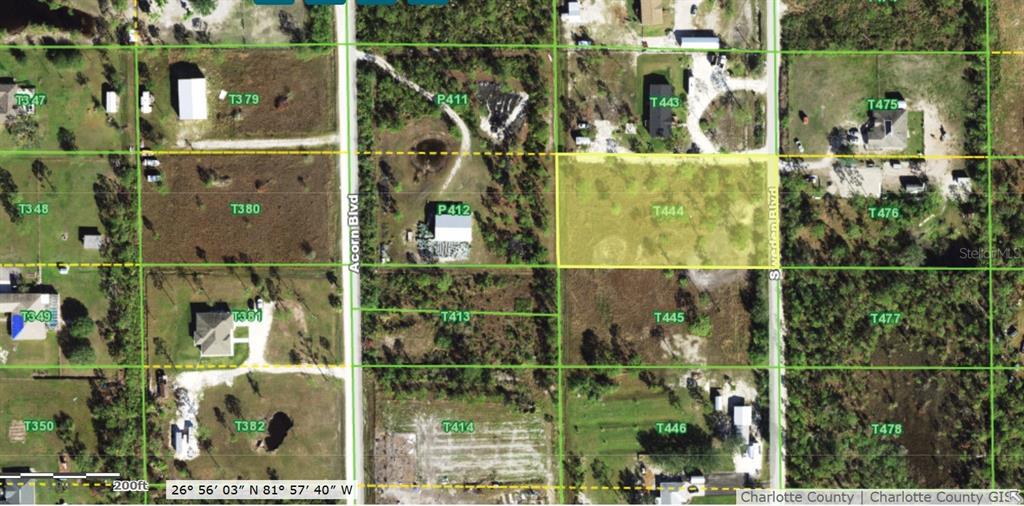 This is a satellite map showing a vacant lot highlighted in yellow among residential properties — 6453 SWEDEN BOULEVARD, PUNTA GORDA, FL