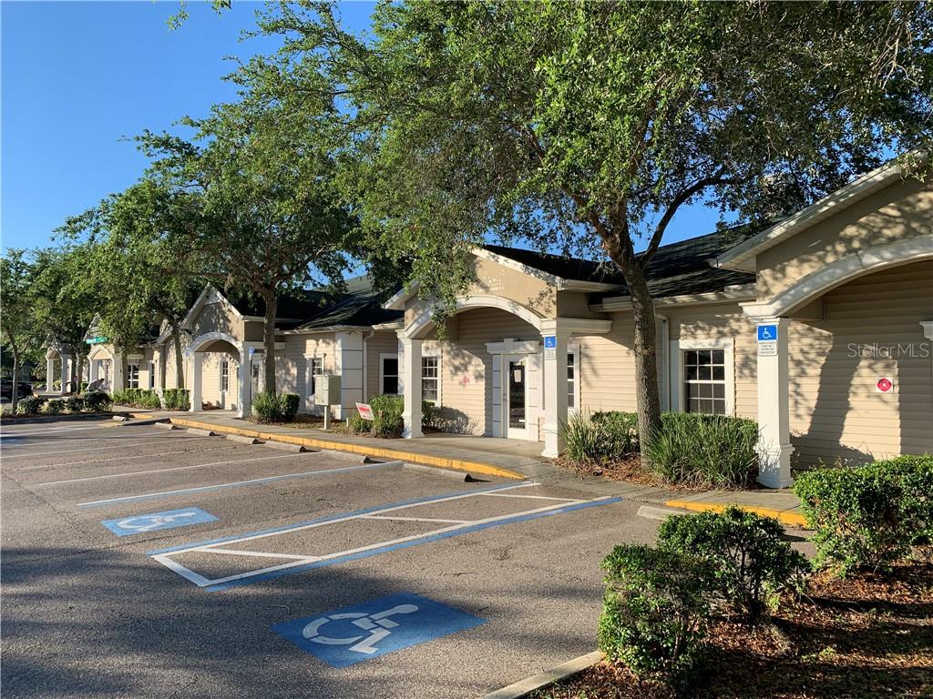 An exterior view of a commercial building with a parking lot and handicap-accessible spaces — 5140 DEER PARK DRIVE, NEW PORT RICHEY, FL