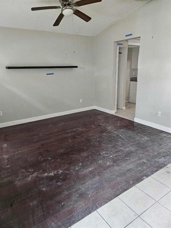 A room with dark wood flooring, a ceiling fan, and a wall-mounted shelf — 1929 SEDGEFIELD STREET, BRANDON, FL