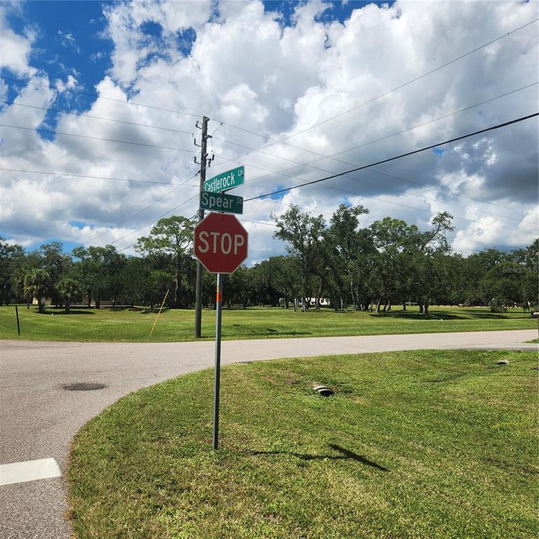 A stop sign stands at the intersection of Castlerock Lane and Spear Street — 1587 CASTLEROCK LANE, PORT CHARLOTTE, FL