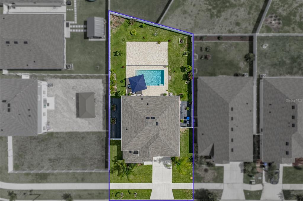 An aerial view shows a residential property with a house, swimming pool, and fenced backyard — 12756 TANNENCREST DRIVE, RIVERVIEW, FL