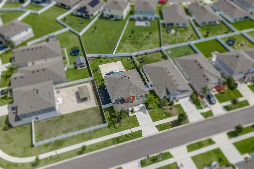 An aerial view shows a suburban house with a fenced backyard and a paved driveway — 12756 TANNENCREST DRIVE, RIVERVIEW, FL