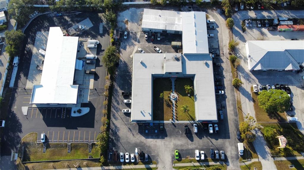 An aerial view shows two commercial buildings with parking lots and a central courtyard — 37542 US HWY 19 N, PALM HARBOR, FL
