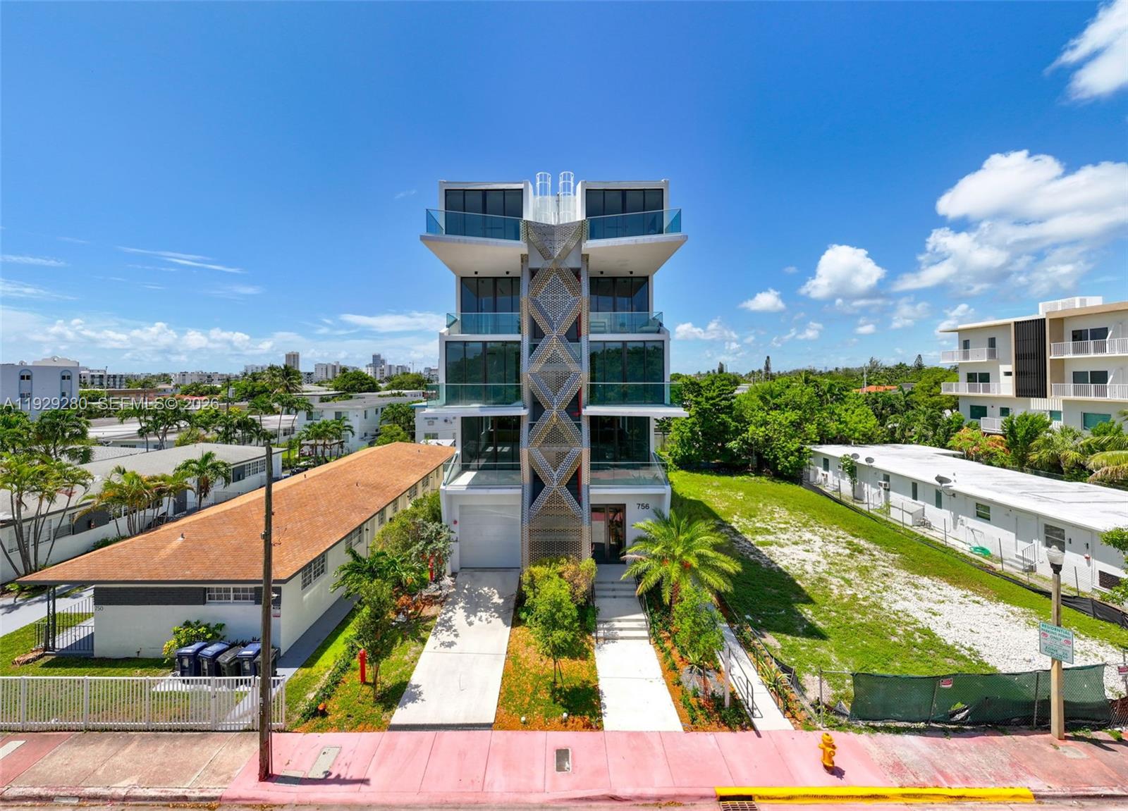 A modern multi-story residential building features a central decorative lattice facade and glass balconies — 756 84th St # B, Miami Beach FL 33141, MIAMI BEACH, FL