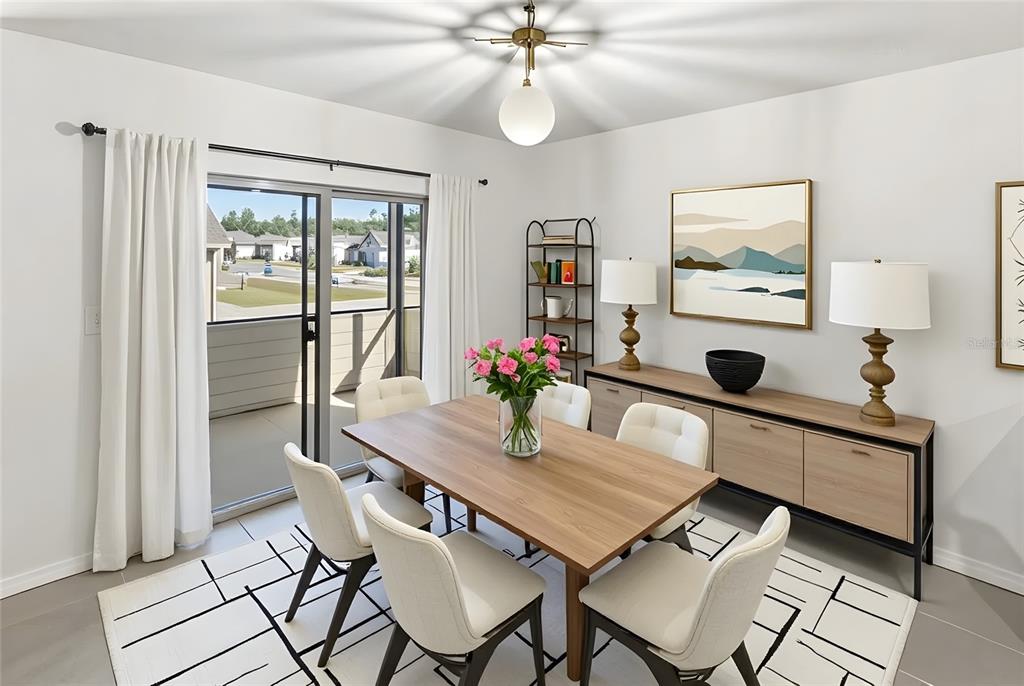 A dining room features a wooden table, white chairs, a sideboard, and a sliding glass door — 22608 NW 196TH LANE, HIGH SPRINGS, FL