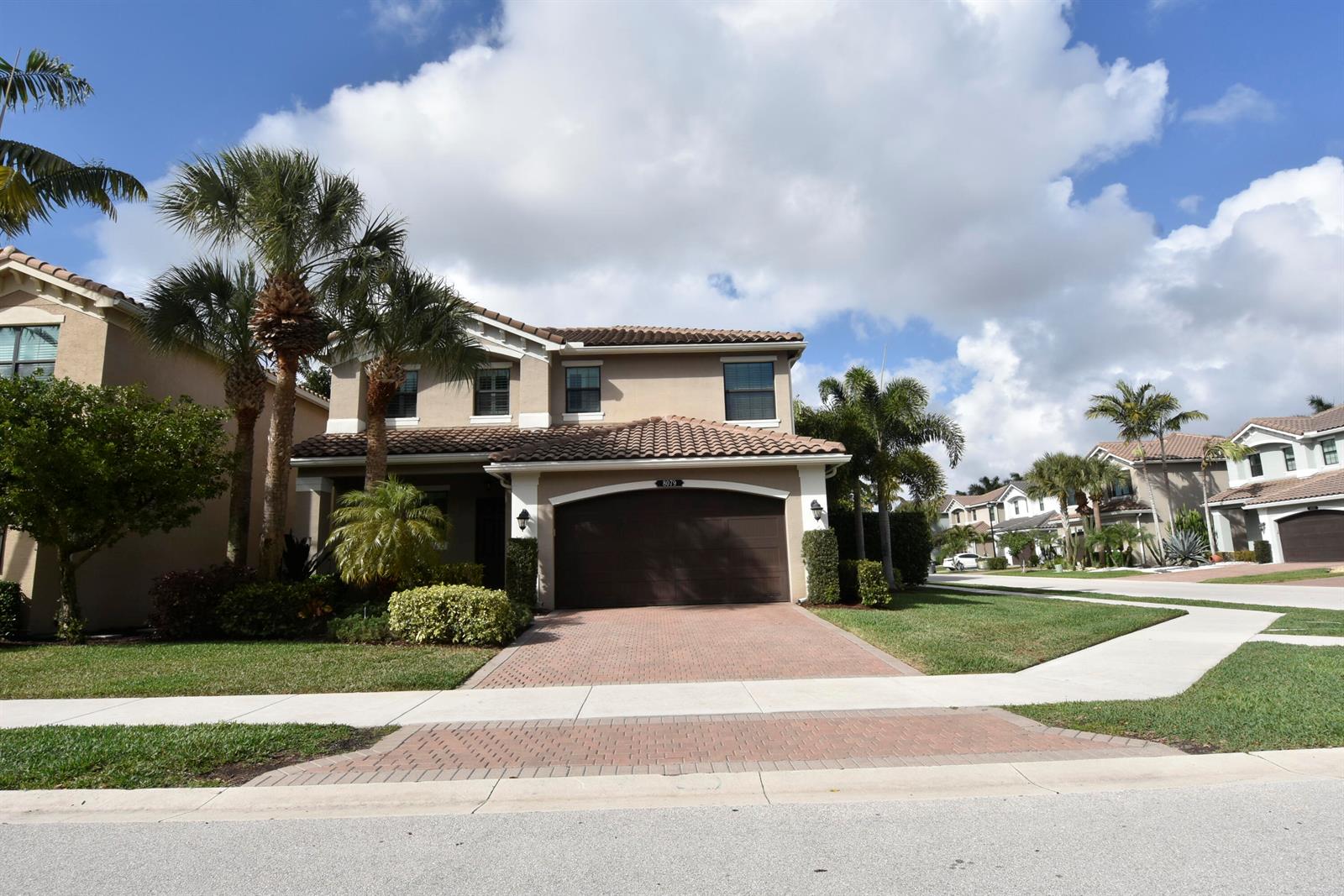 A two-story suburban house with a brown garage and a brick driveway — 8079 Snowflake Obsidian Trail, Delray Beach FL 33446, DELRAY BEACH, FL